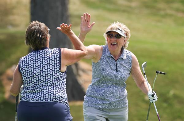 Golfers celebrating with a high five